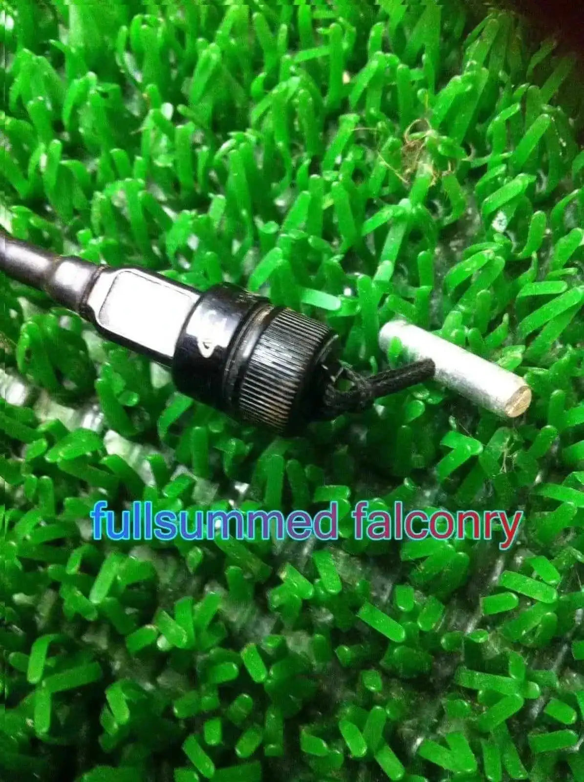 Close-up of black metal falconry bullet toggle assembly