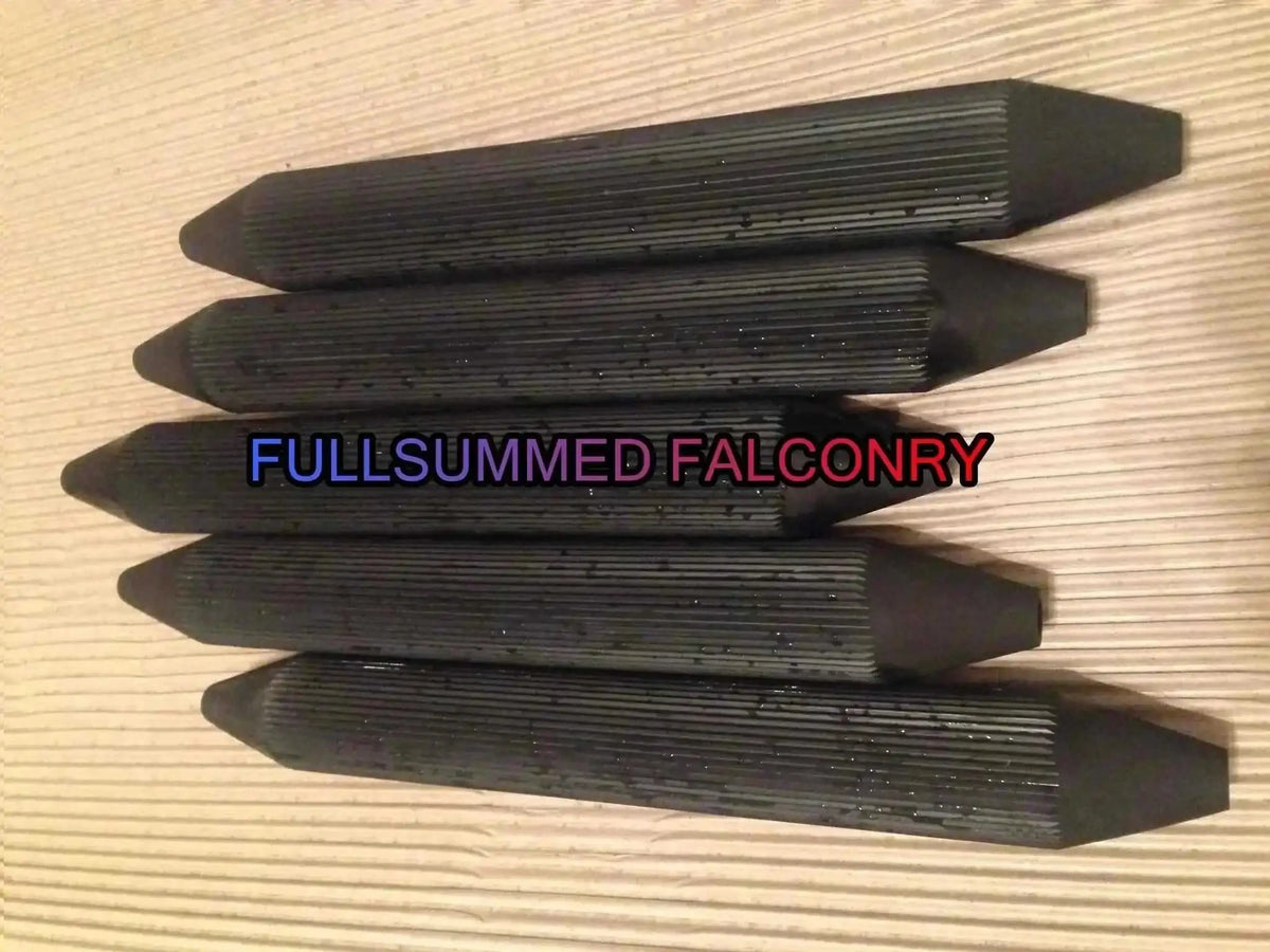 Stack of black fluted falconry perch rubber grips for secure bird handling