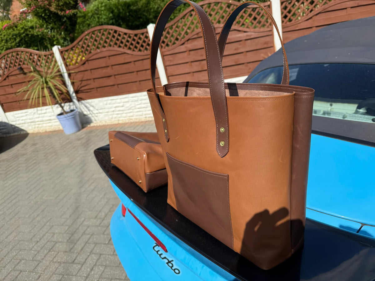 Stylish handmade leather tote bag in brown, showcased on a car, by FULLSUMMED FALCONRY.