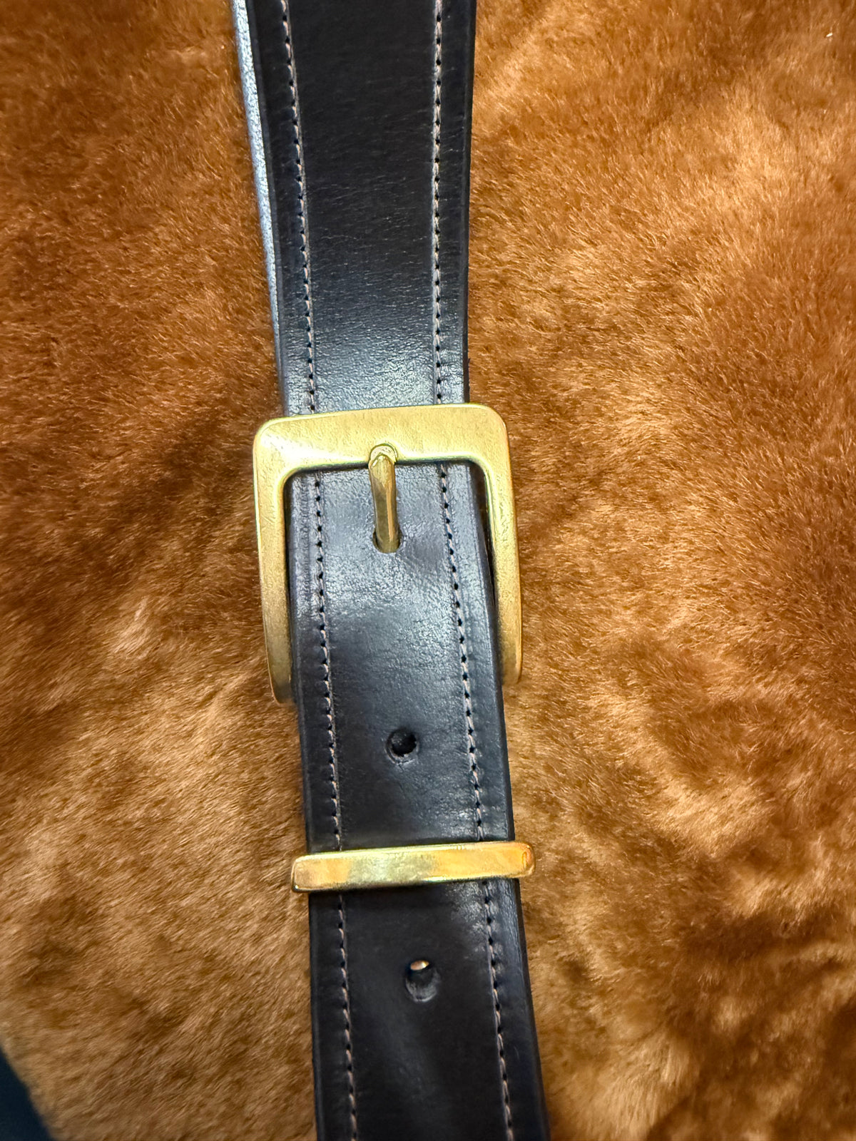 Premium leather belts for everyday use with a gold buckle on a soft background.