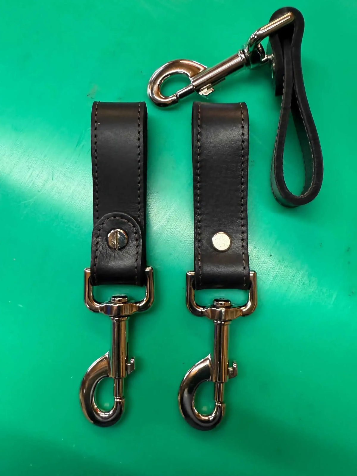 Black leather falconry bag clip with silver trigger hook and stitching